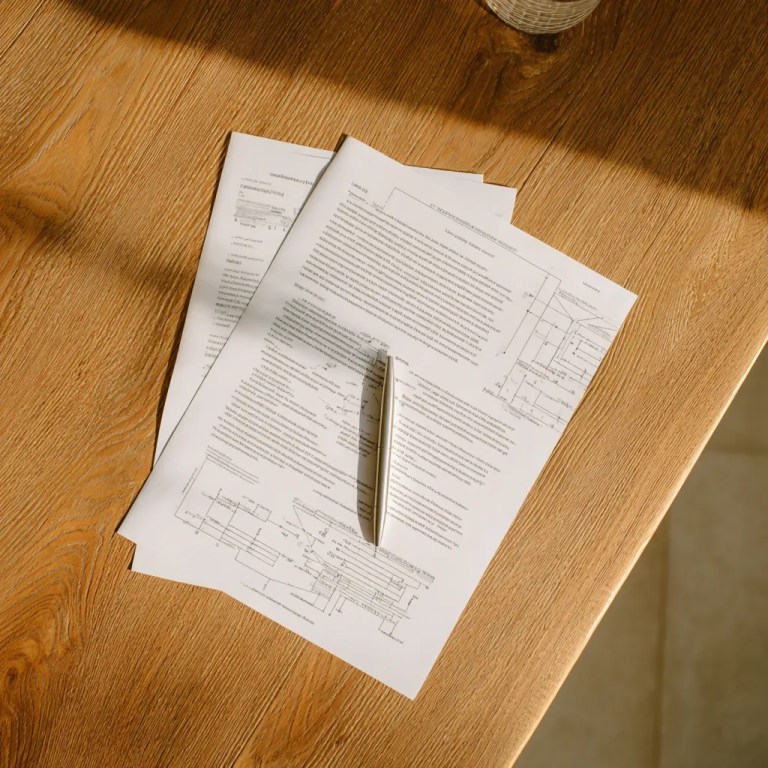 A pen on top of financial papers